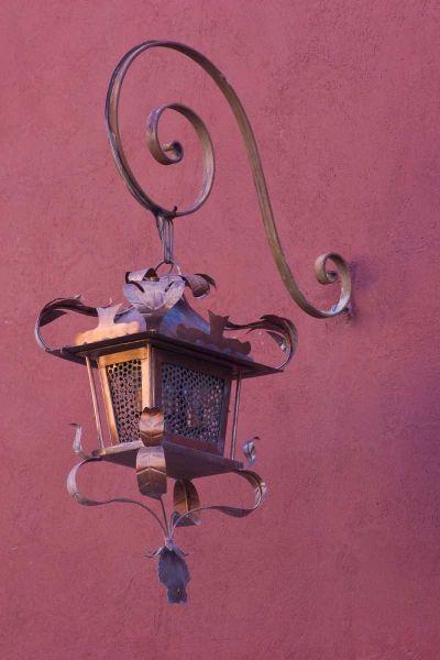 Mexico Copper lamp hung from pink-purple wall